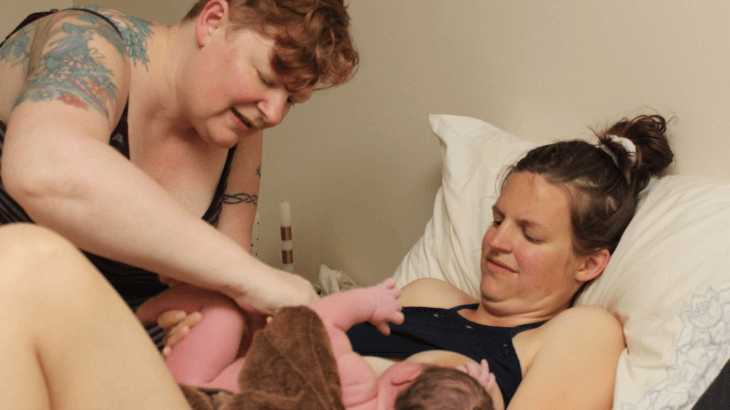 Midwife, mom and baby after birth